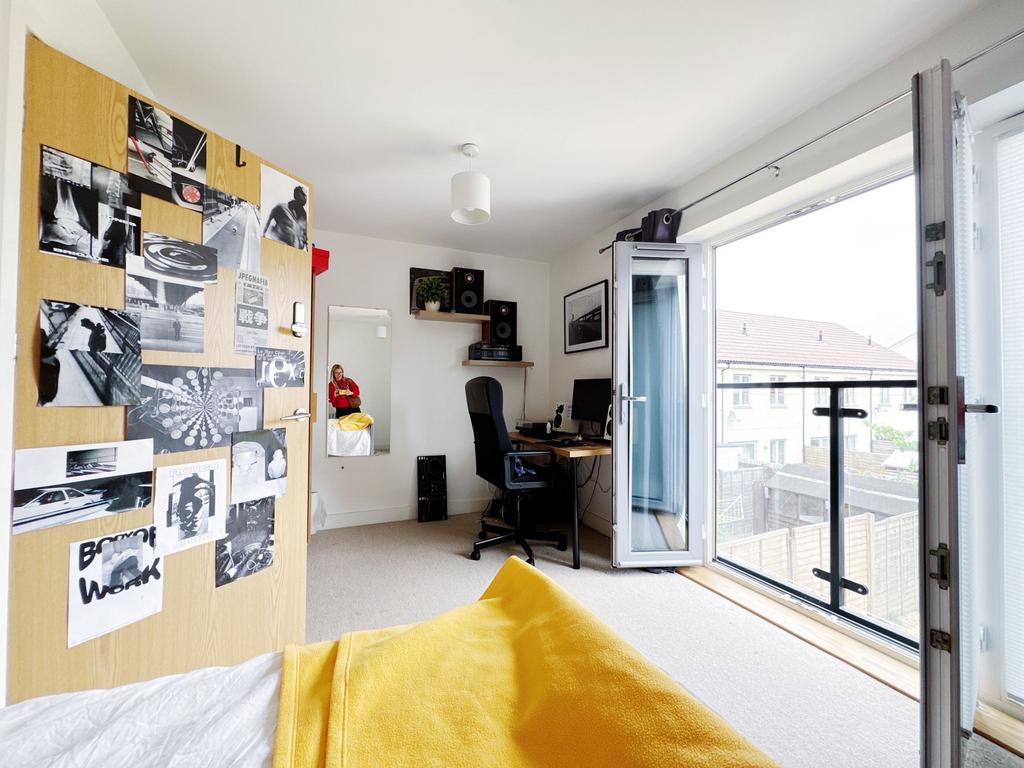 Bright, modern bedroom with large floor-to-ceil...
