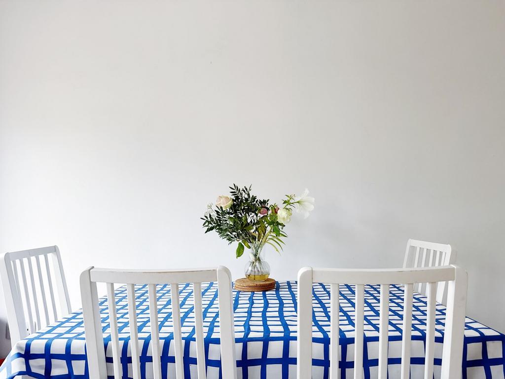 Bright, minimalist dining area with a patterned...