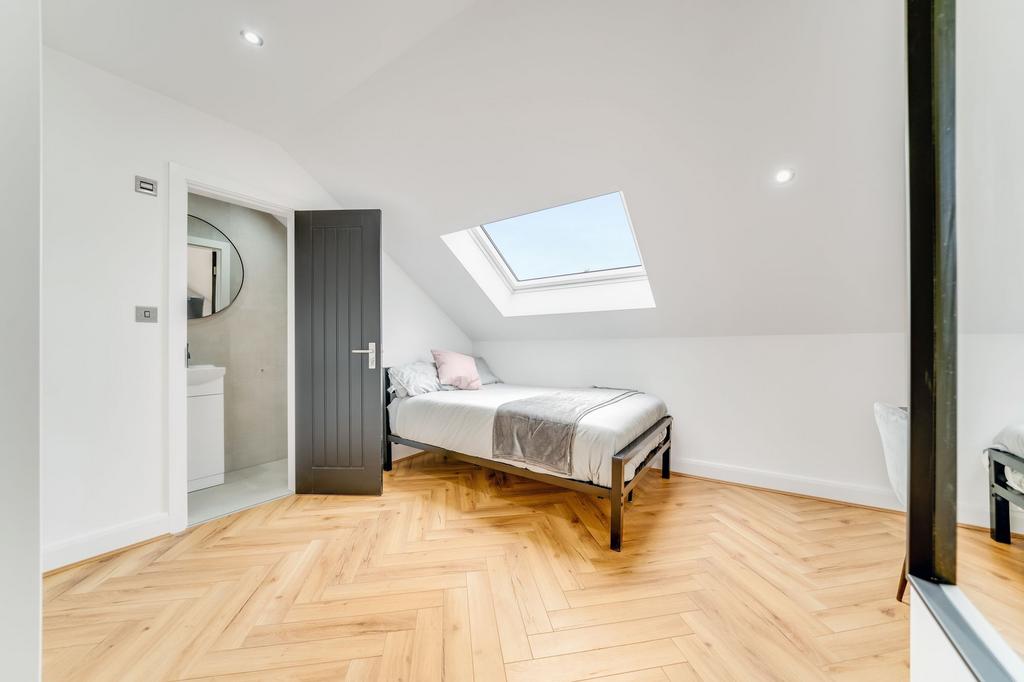 Bright and modern bedroom with a skylight provi...