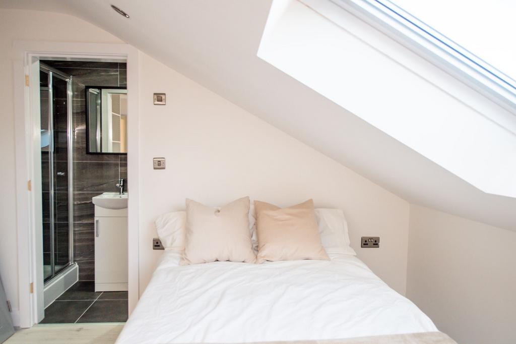 A bright and inviting bedroom featuring a large...