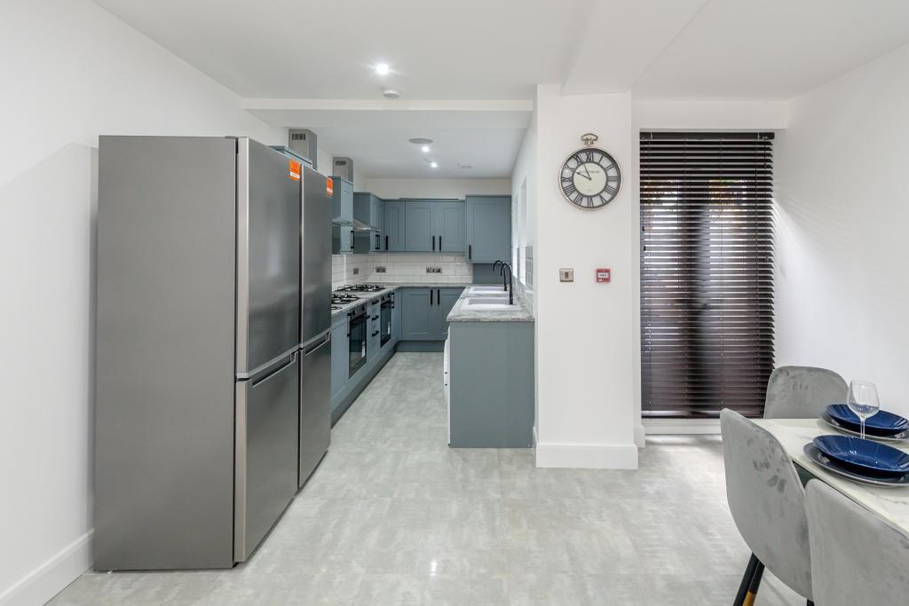A modern, well-organized kitchen featuring stai...
