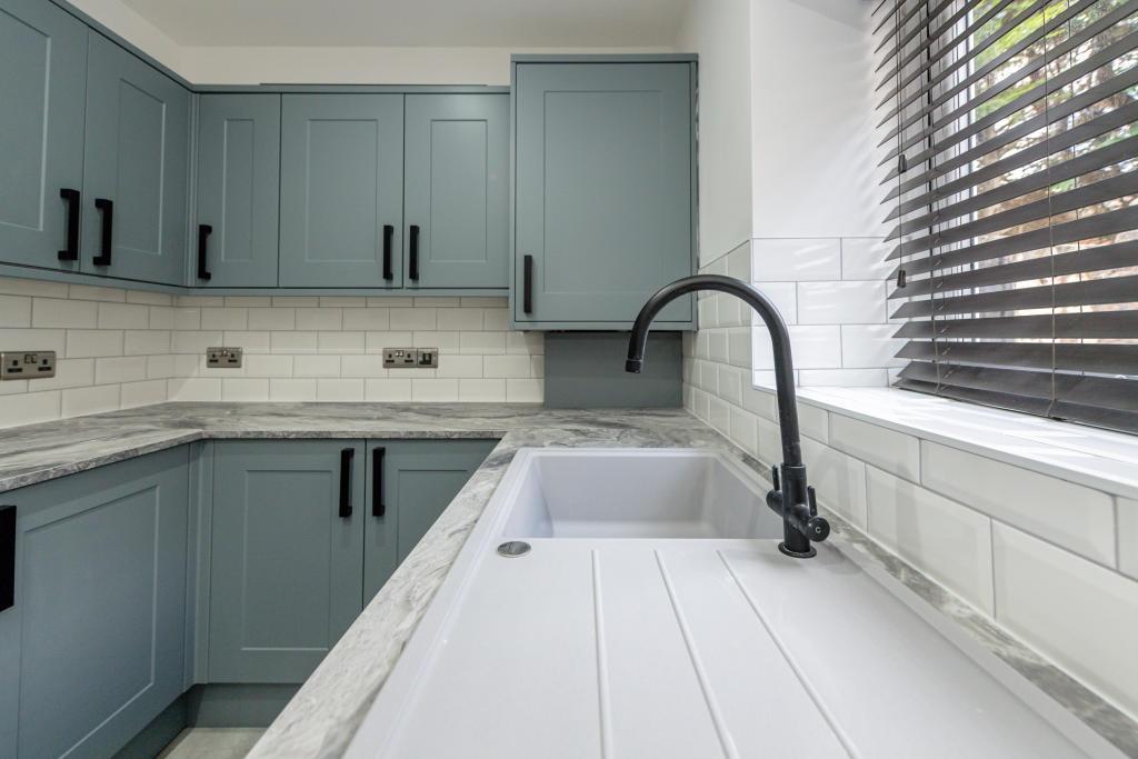 A modern kitchen featuring a clean, minimalist ...
