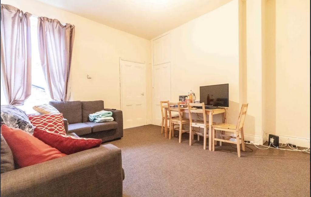 Bright communal living room with comfortable so...