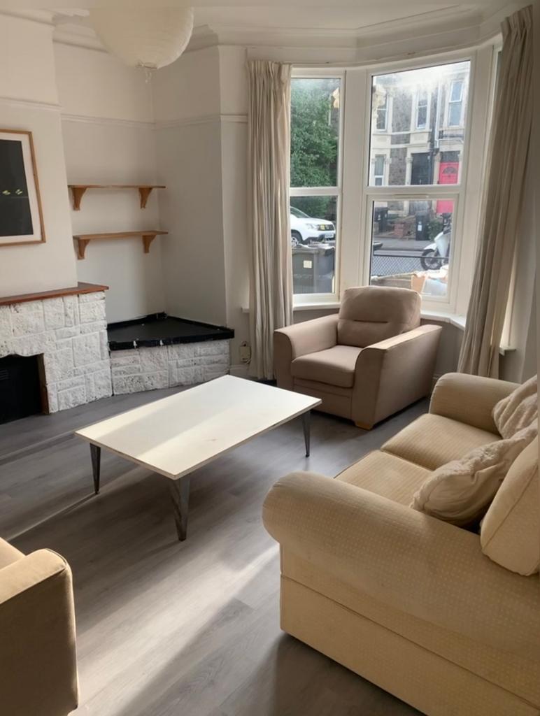 A bright and inviting living room with ample na...