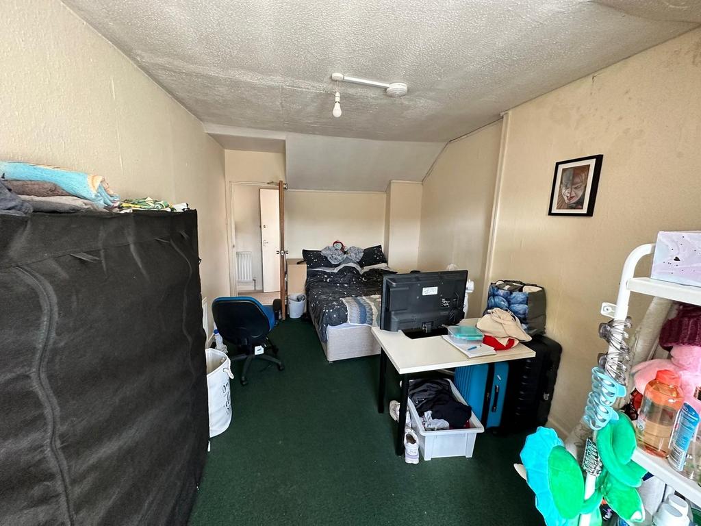 A spacious and inviting double bedroom with amp...