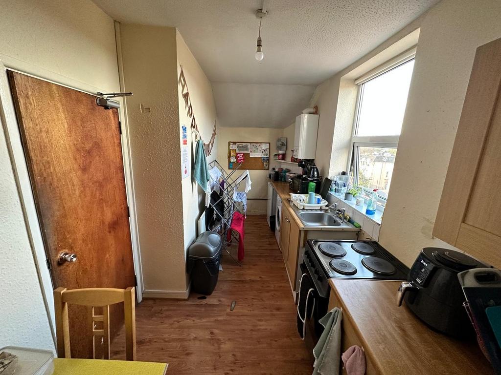 A well-lit kitchen with ample storage and works...