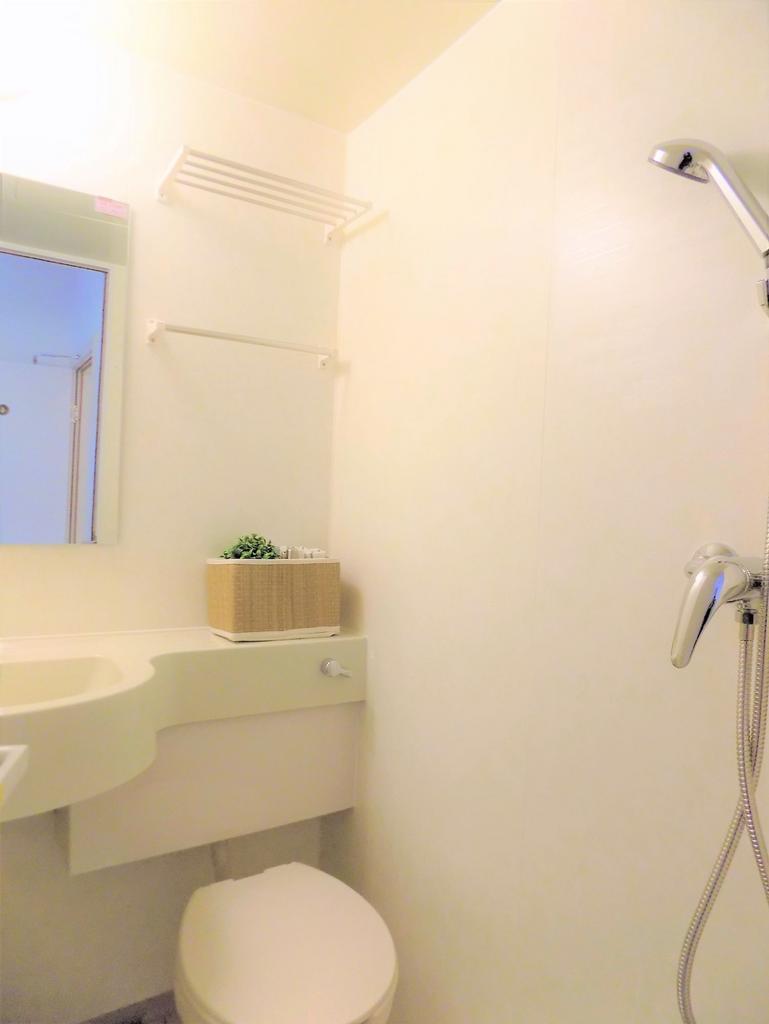 Compact, tidy bathroom with a modern shower hea...