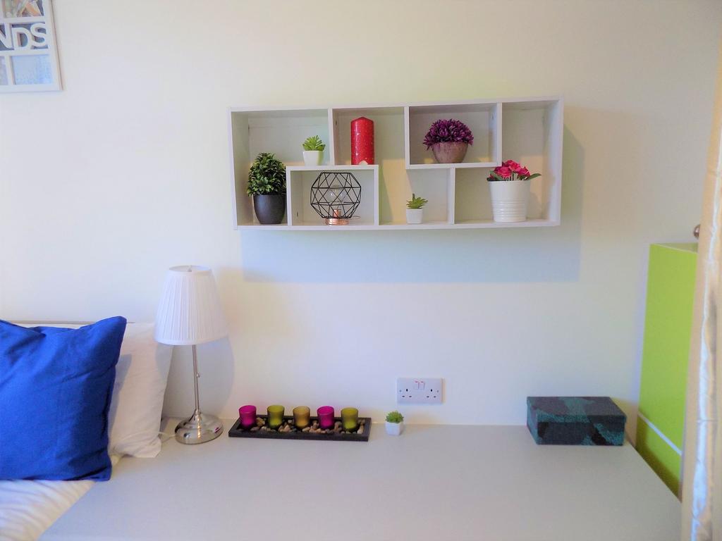 Bright, tidy bedroom corner with a comfortable ...