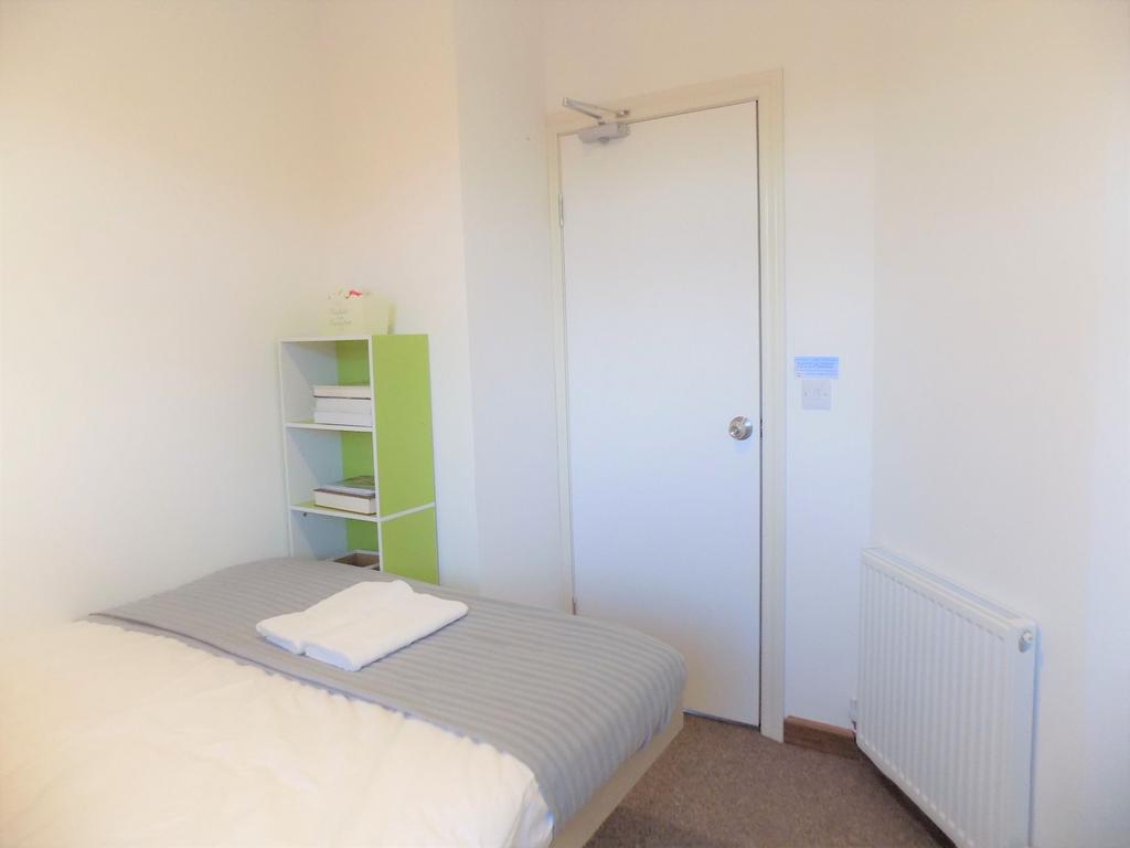 Bright, simply furnished single bedroom with a ...