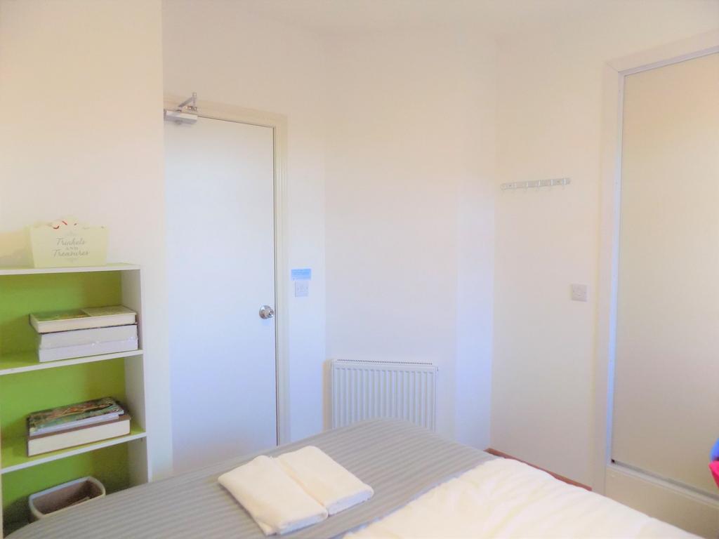 Bright, neatly presented bedroom with a made do...