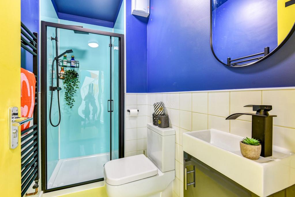 Bright, modern bathroom with a frameless glass ...