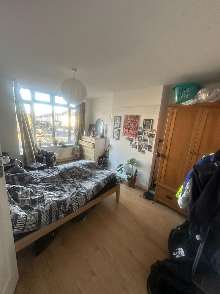 Bright double bedroom with a large front window...