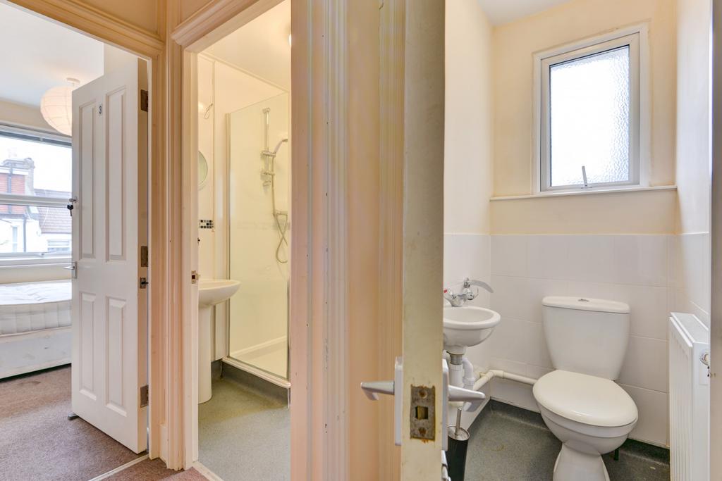A clean and bright bathroom featuring a toilet,...