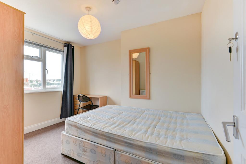 Bright, simply furnished double bedroom with a ...