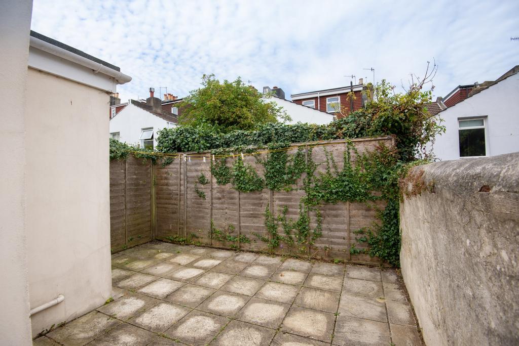 Private paved rear courtyard with high boundary...