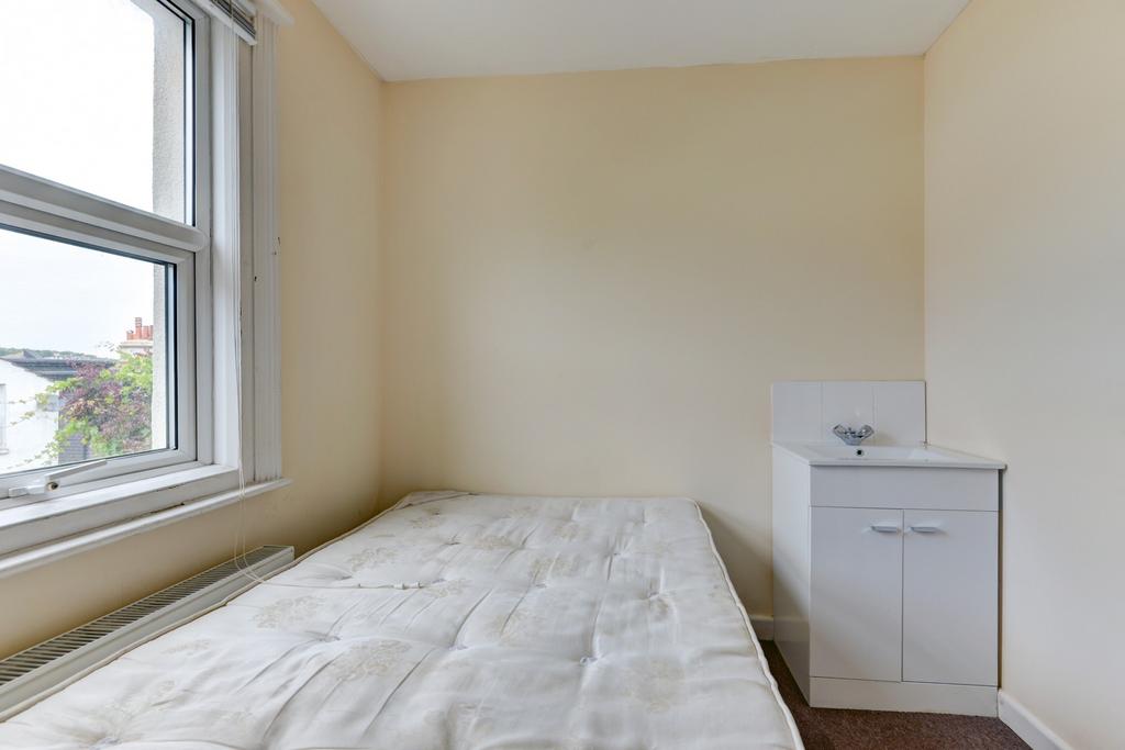 Bright bedroom with a comfortable double bed po...