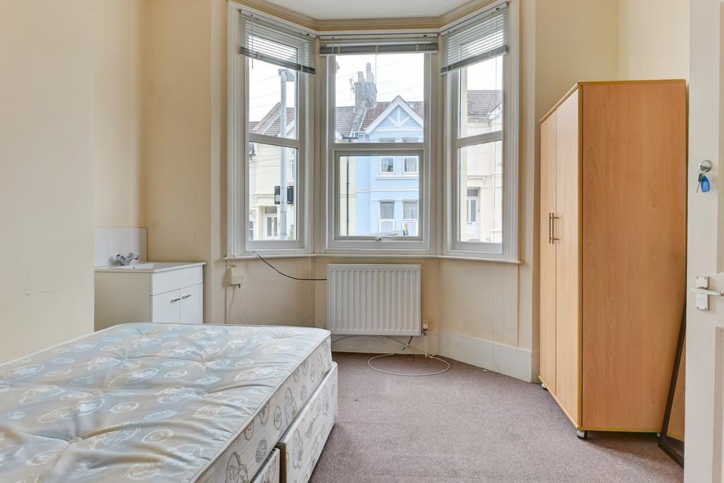 A bright and spacious master bedroom with a lar...
