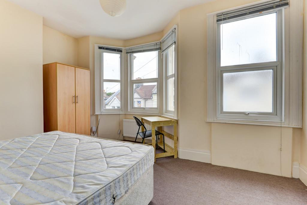 A bright and well-maintained bedroom featuring ...