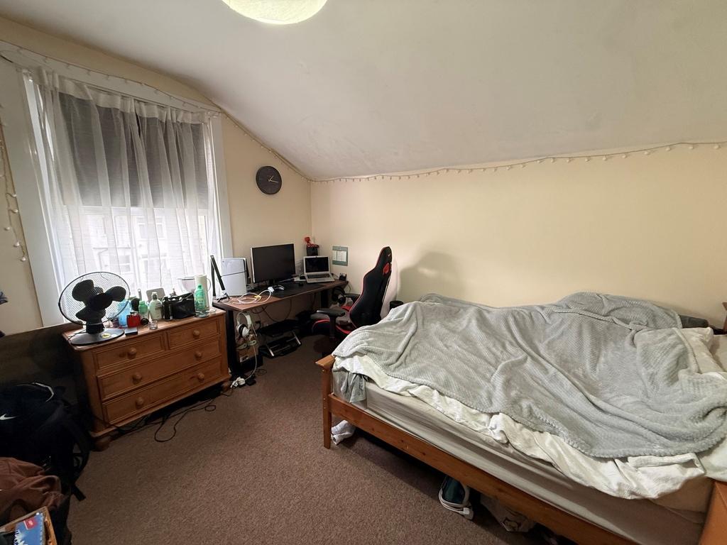 Bright attic double bedroom with a large window...