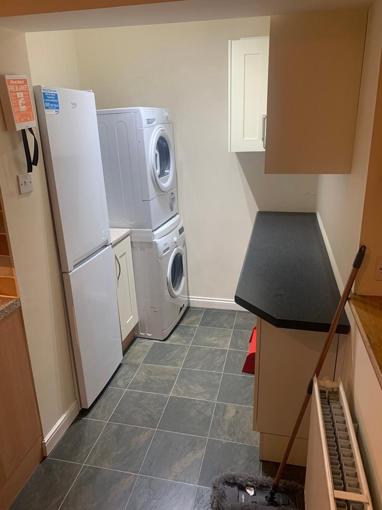 A functional kitchen space with essential appli...