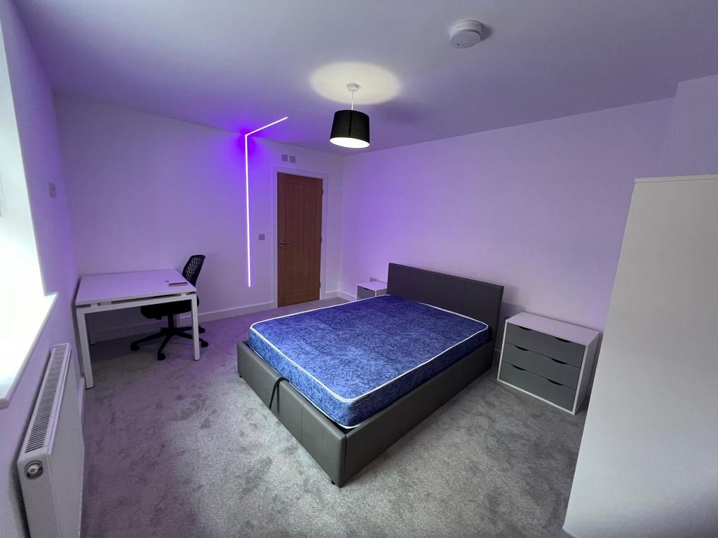 Bright, modern bedroom with a comfortable uphol...