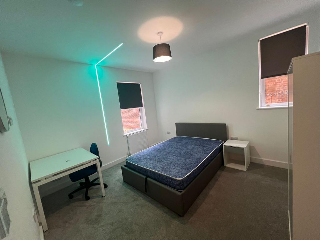 Bright, modern double bedroom with a comfortabl...