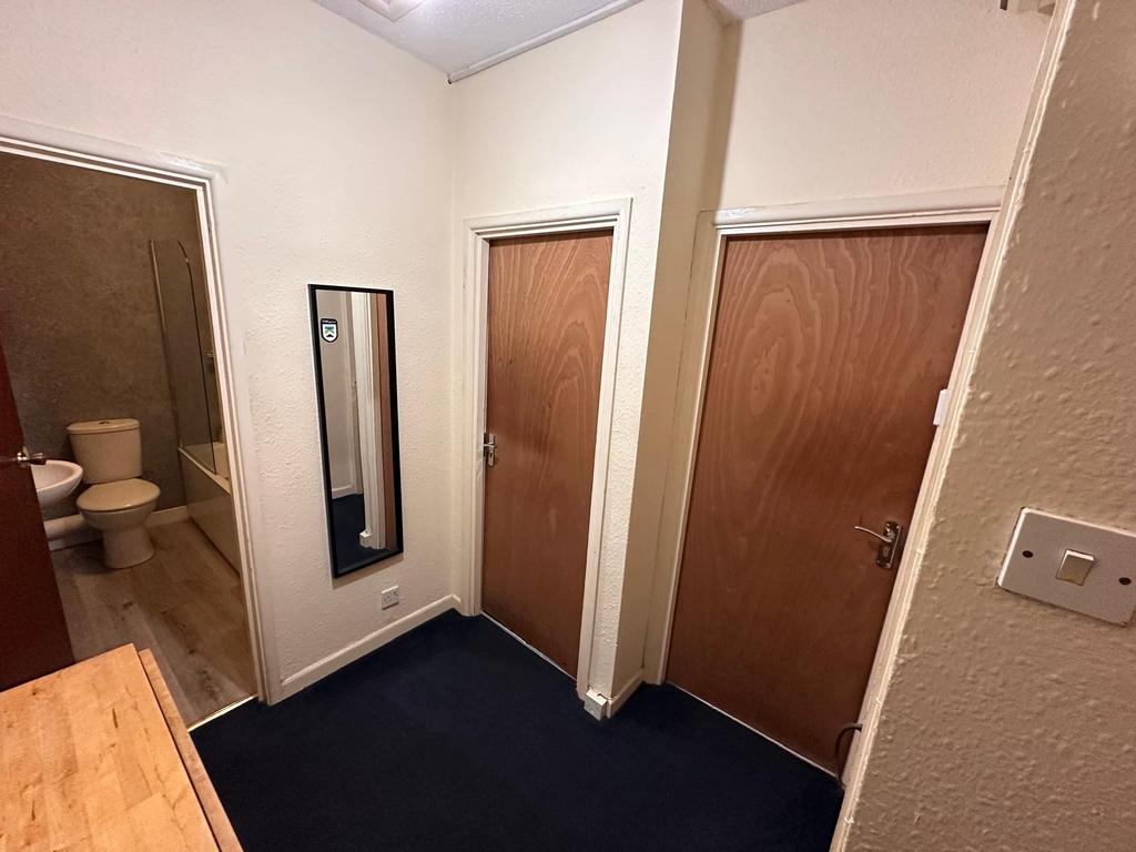 Neat entrance hallway with dark carpet, a full-...