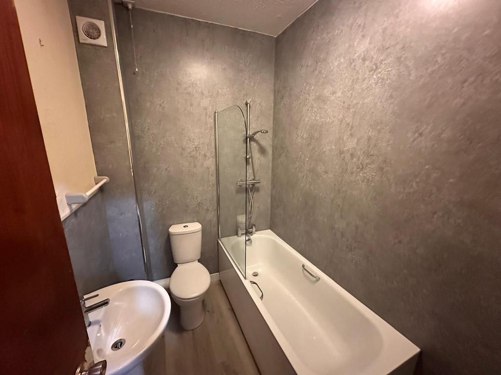 Neat modern bathroom with a white bathtub and s...