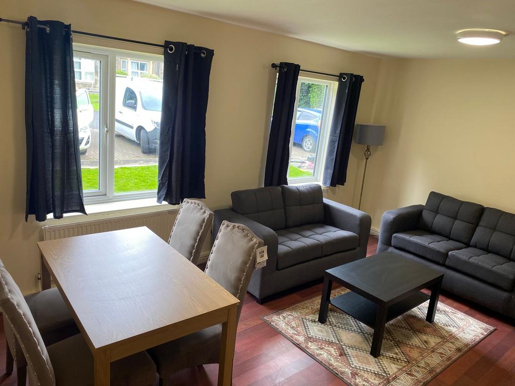 A bright and inviting living room featuring two...