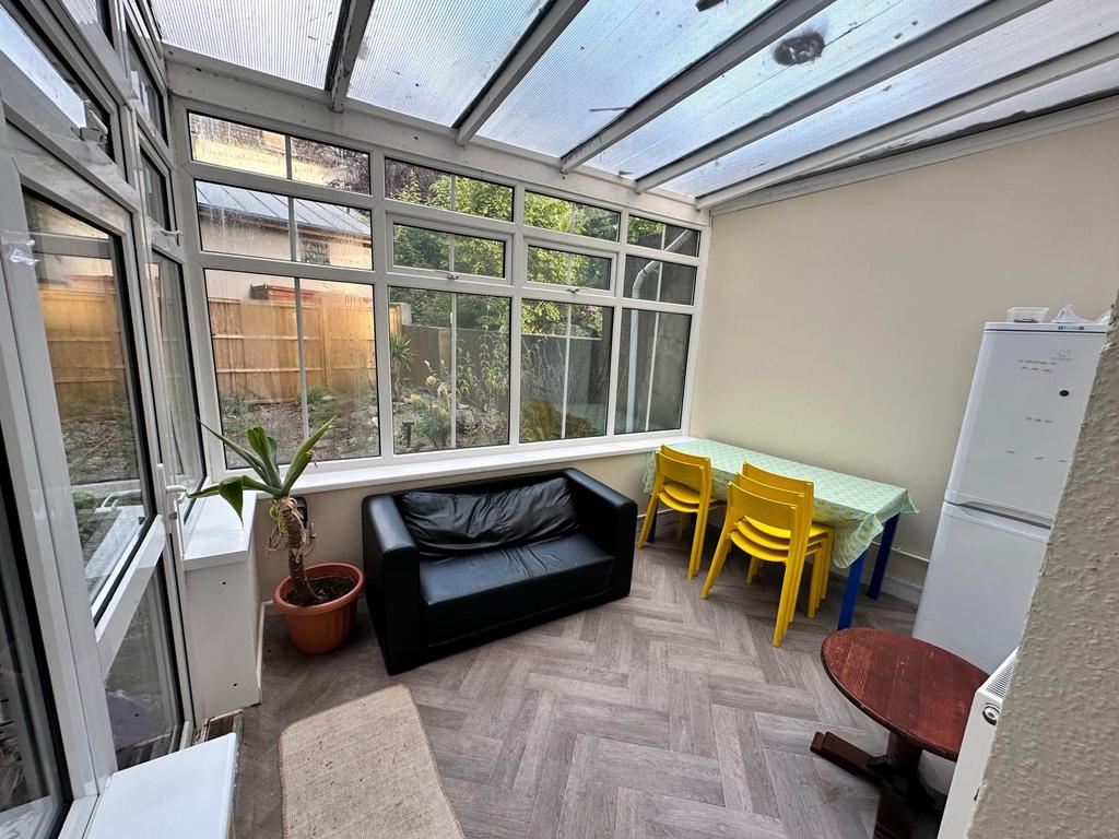 Bright conservatory-style communal lounge with ...