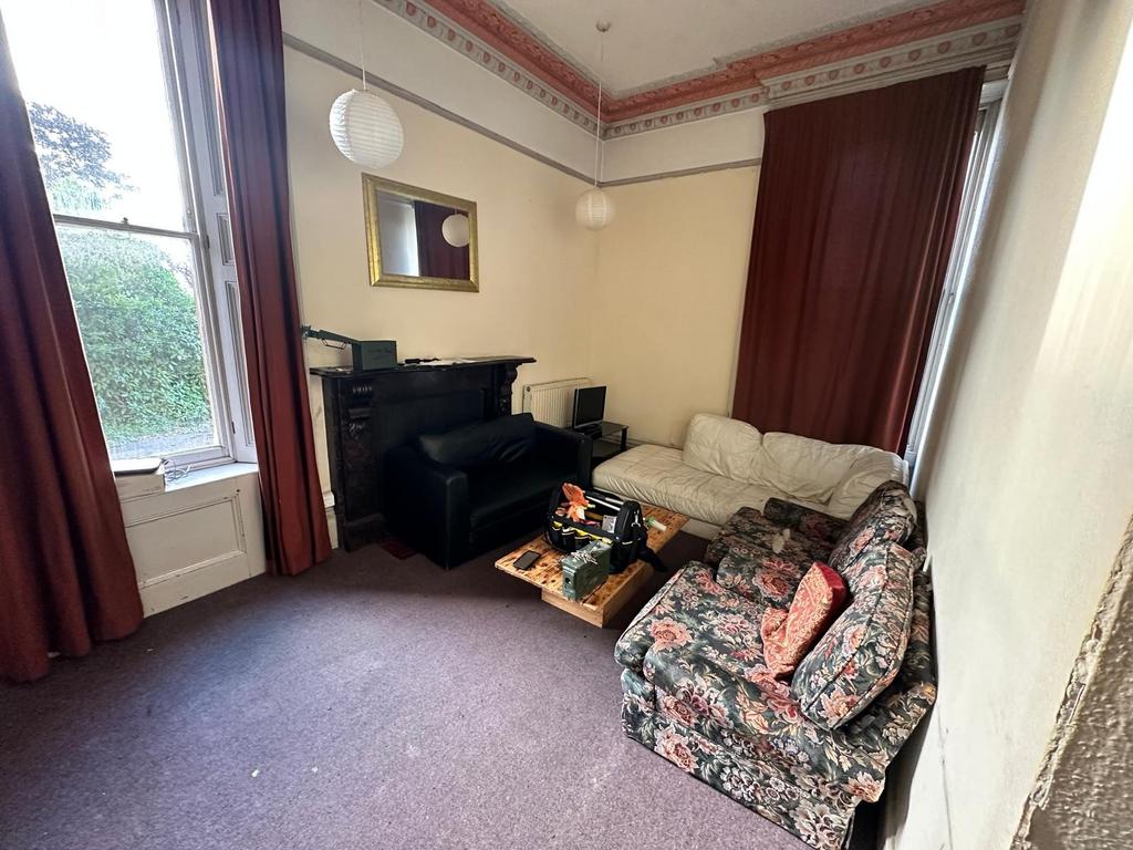 Bright period living room with high ceilings, t...