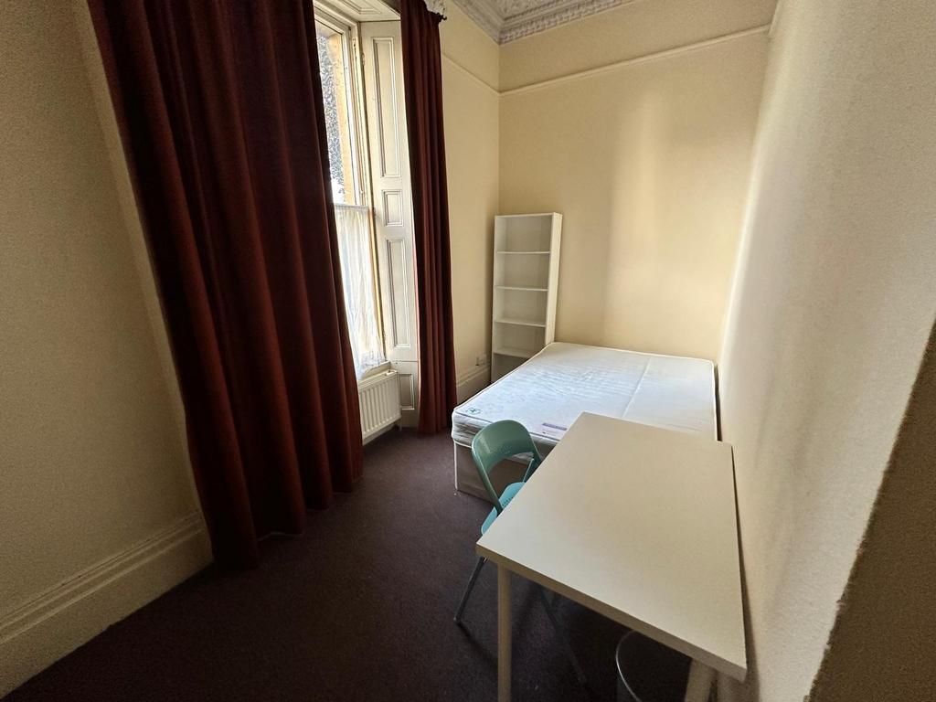 Bright single bedroom with high ceilings, tall ...