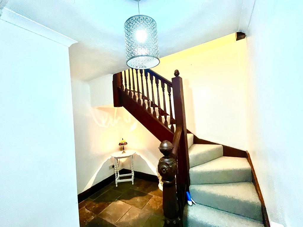 Bright, well-kept entrance stairway with a clas...