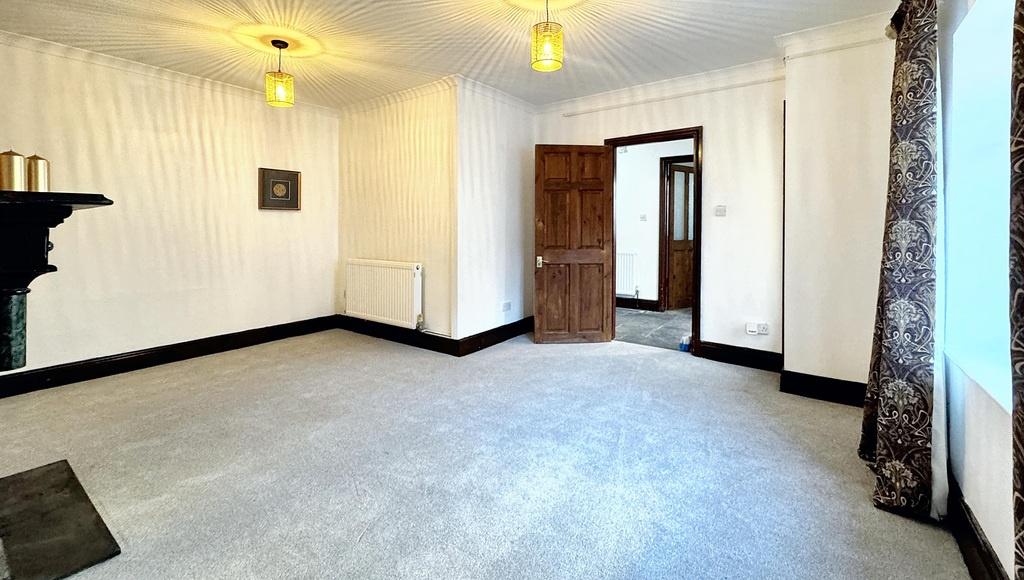 Bright, neutral living room with large windows,...