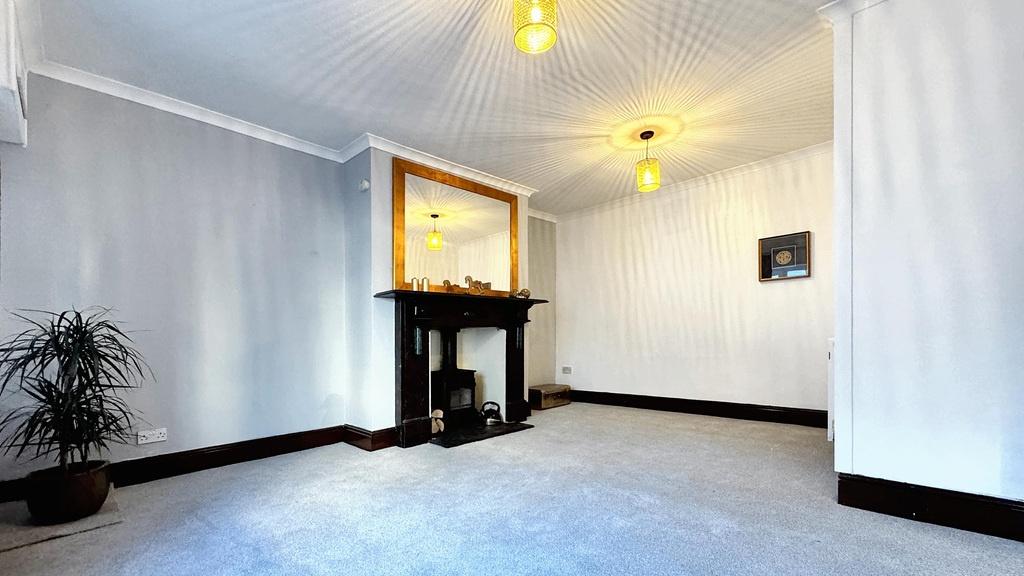 Bright, neutral living room with decorative fir...