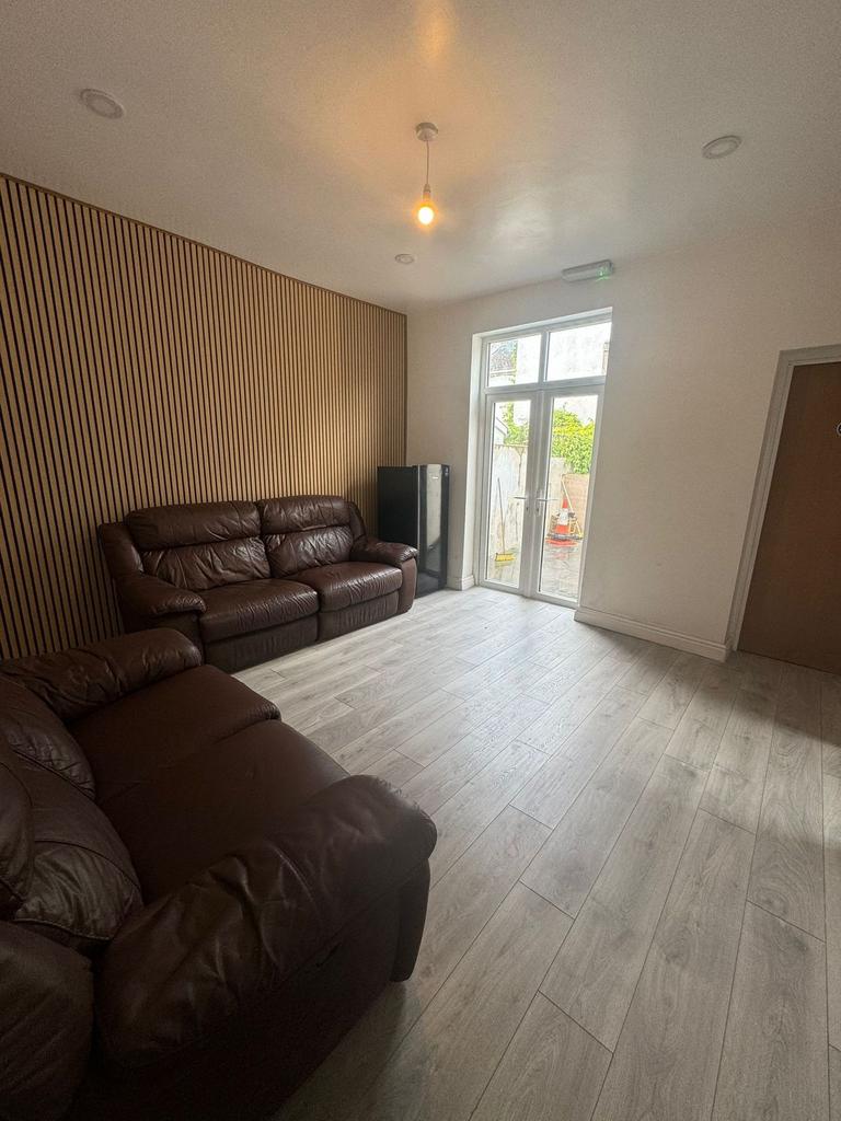 Contemporary living room with two brown leather...