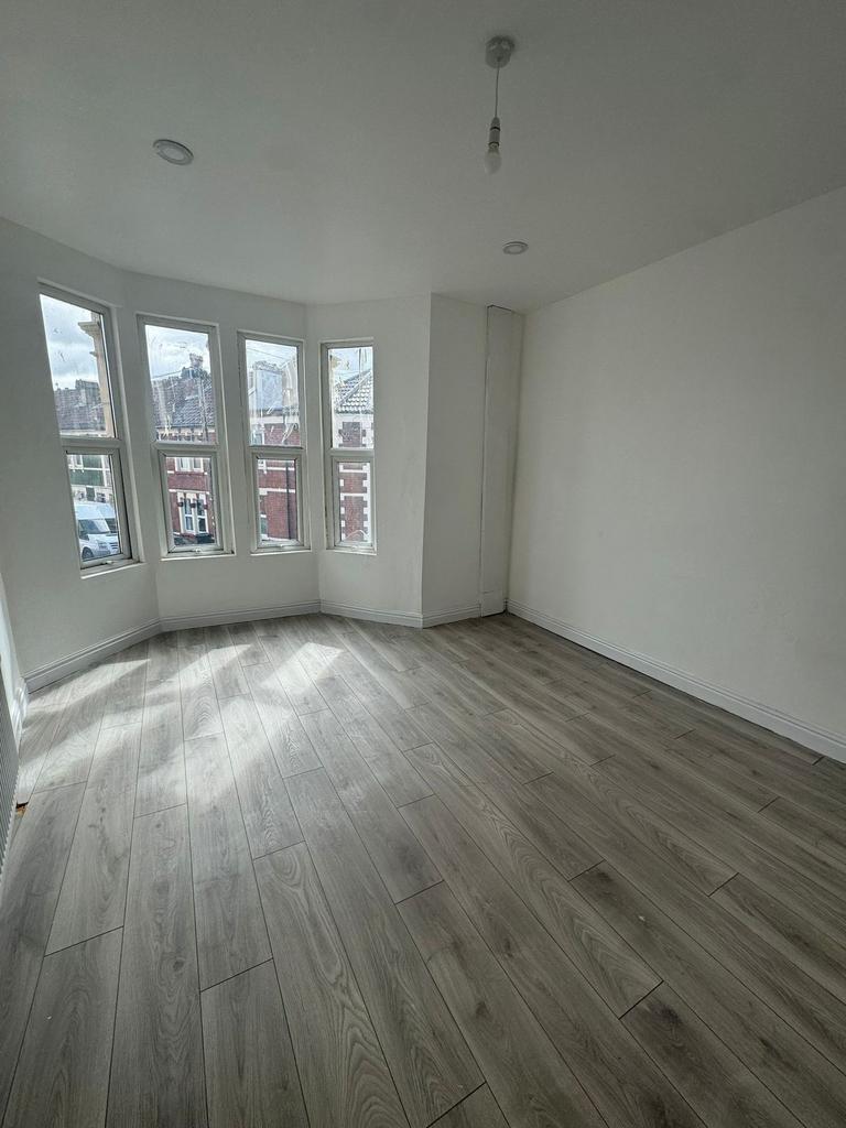 Bright, freshly renovated bedroom with a bay of...