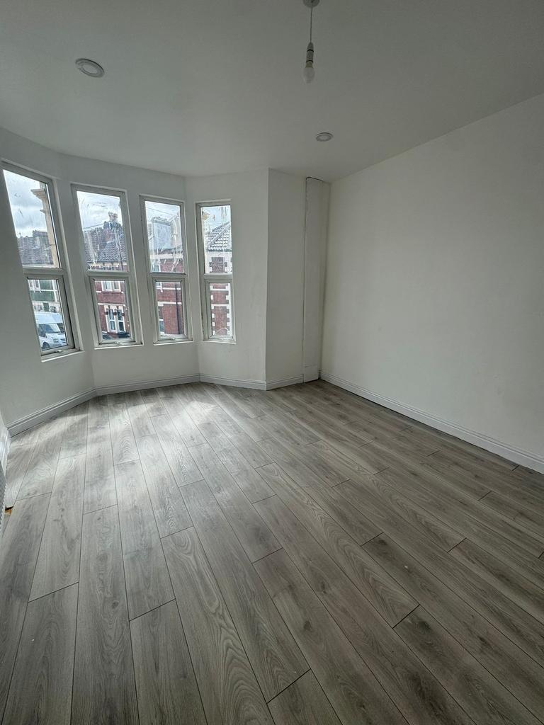 Bright, freshly renovated bedroom with a bay of...