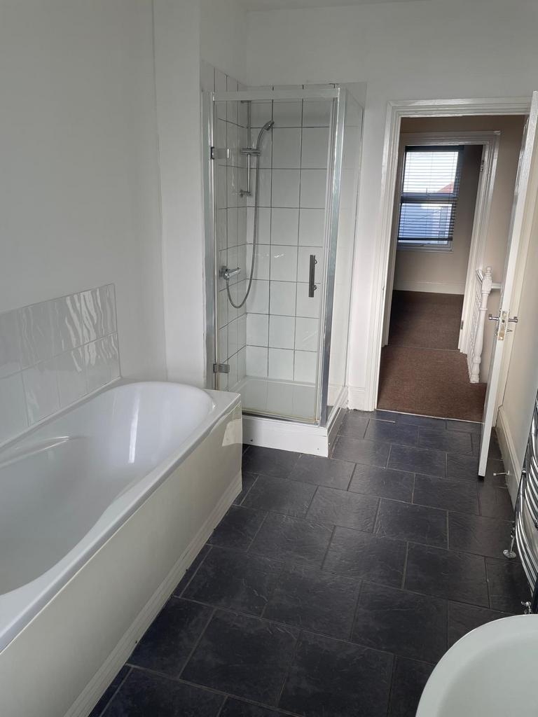 Bright, modern bathroom with a separate walk-in...
