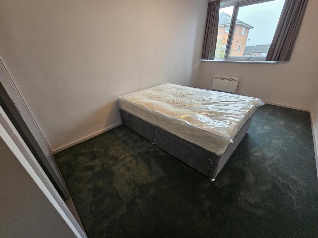 Bright, simply furnished double bedroom with a ...