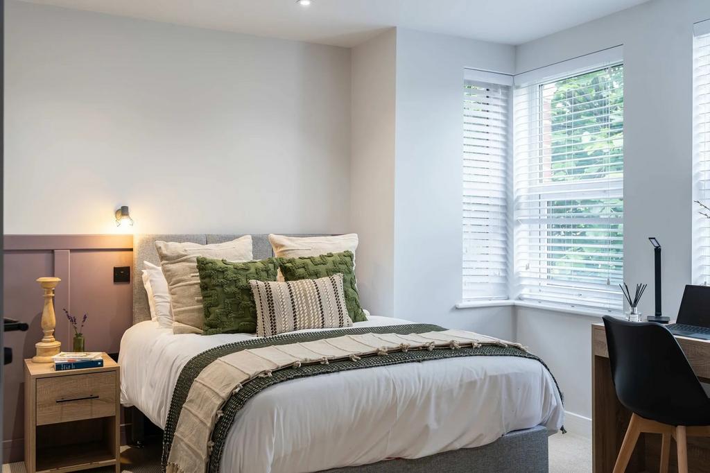 A modern and inviting master bedroom featuring ...