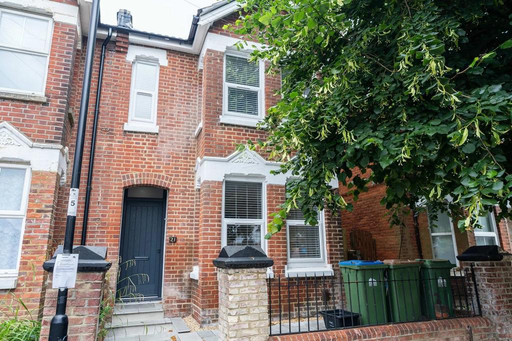The exterior of a charming brick townhouse feat...