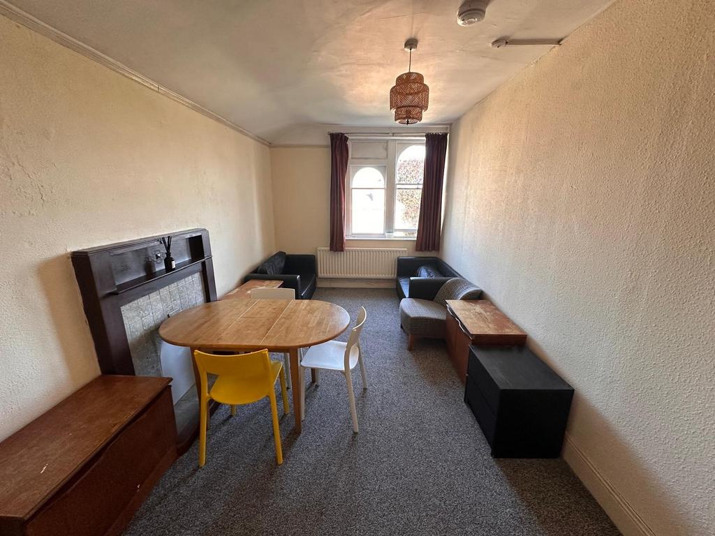 Long, narrow living room with a central wooden ...