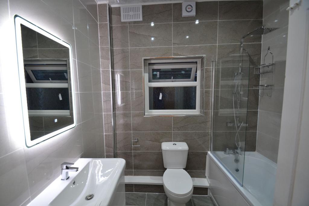 Modern bathroom featuring a sleek sink, a large...