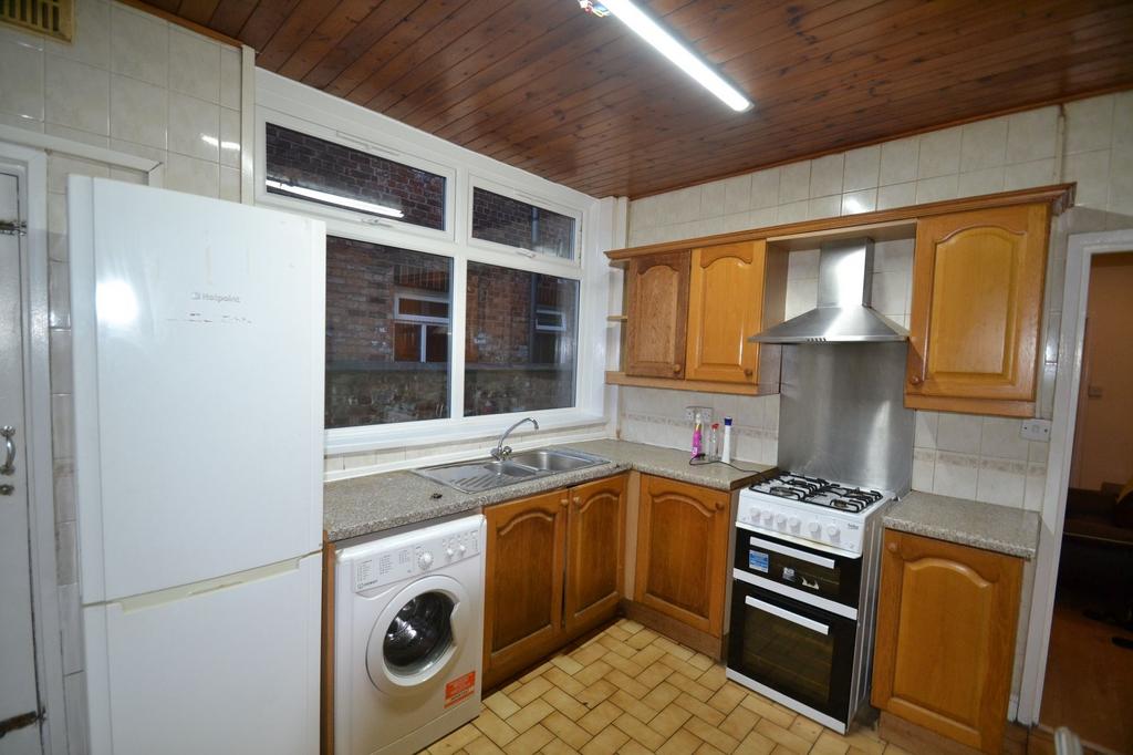A well-maintained kitchen with ample natural li...
