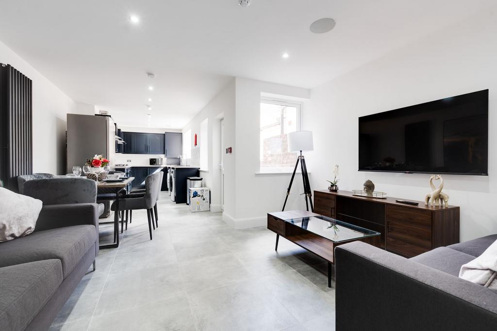 Bright and modern living room featuring ample n...