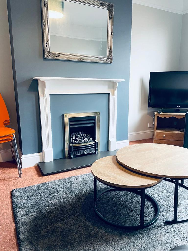 Stylish living room with a decorative fireplace...