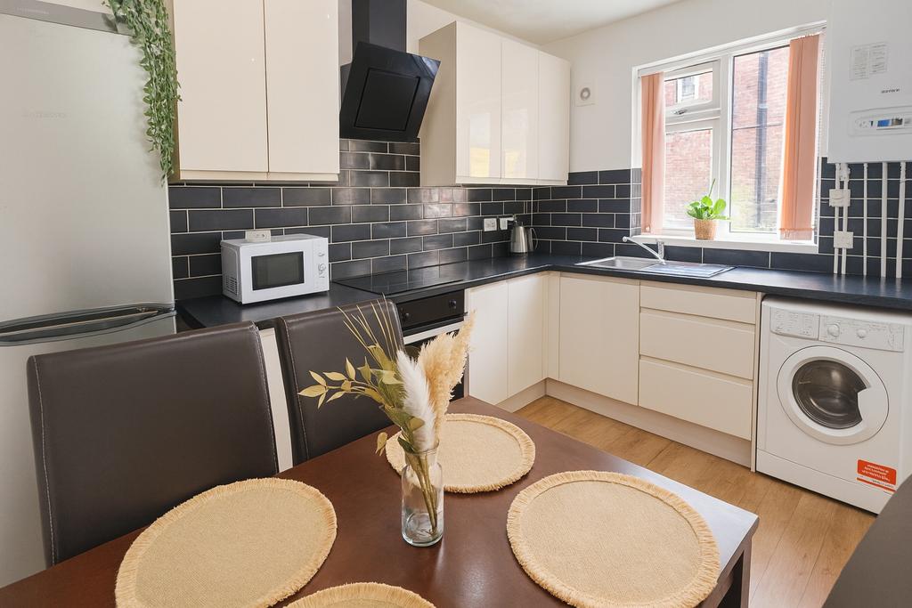 Bright and modern kitchen featuring sleek black...