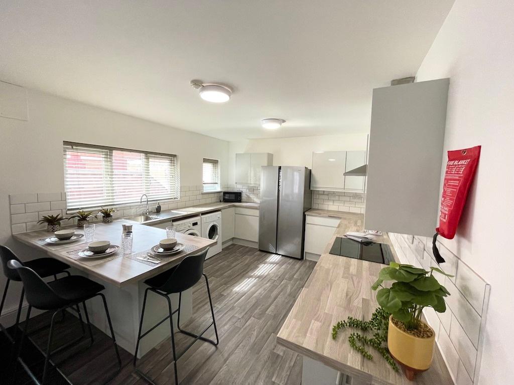 Bright modern kitchen with a breakfast bar, int...