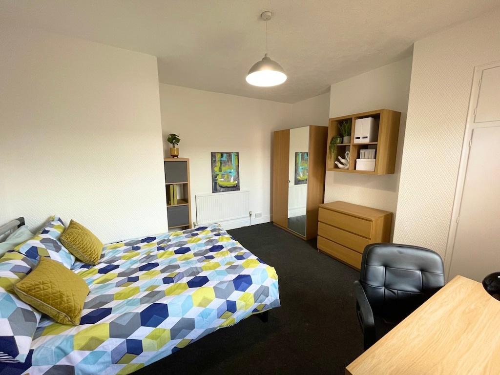 Bright, well-appointed bedroom with a patterned...